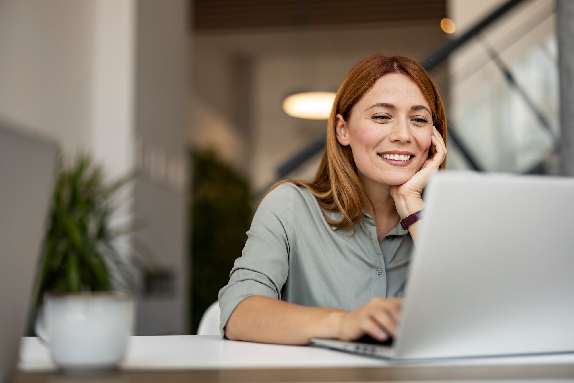 iStock-2187502380_corporate_female_office smiling laptop
